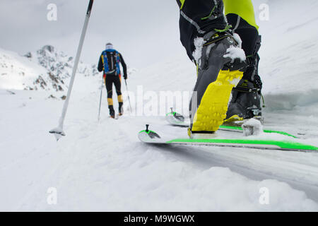 Ski mountaineering boot detail during ascent in the snow. Stock Photo