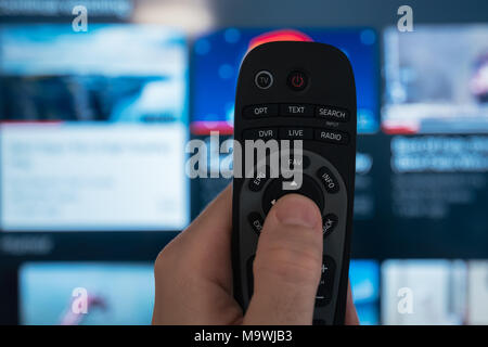 Male hand with smart TV remote controller, selective focus Stock Photo