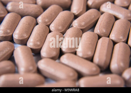 macro closeup of a pills on a wooden table. health and medical concept Stock Photo