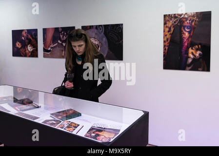 London, UK.  28 March 2018.  Visitors view works at the preview of 'The Series', an exhibition by Glaswegian street photographer Dougie Wallace at Bermondsey Project Space from 27 March to 14 April.  Works on display are from diverse subjects such as the mega-rich in Harrodsburg, Shoreditch, Blackpool as well as his latest project 'Well Heeled' a street photography book with dogs as the subject.  Credit: Stephen Chung / Alamy Live News Stock Photo