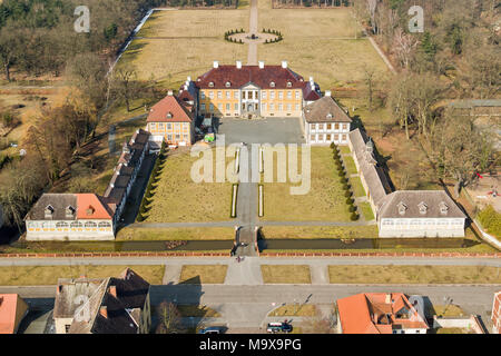 25 March 2018, Germany, Oranienbaum: A cyclist passes the castle Oranienbaum (image taken with a drone). Erected in 1683 as the summer residence for Countess Henriette Catherine of Nassau, wife of John George II, Prince of Anhalt-Dessau, the castle has been undergoing an ongoing restauration for years. The castle and park of the Dessau-Woerlitz Garden Realm are designated a World Heritage Site by UNESCO. Photo: Jan Woitas/dpa-Zentralbild/ZB Stock Photo