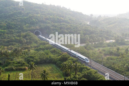 Haikou. 16th Mar, 2018. Photo taken on March 16, 2018 shows a bullet train running on the eastern track of the high-speed loop line near Wanning Railway Station, south China's Hainan Province. The 653-km high-speed railway line circling the island received over 25 million passengers in 2017. Credit: Yang Guanyu/Xinhua/Alamy Live News Stock Photo