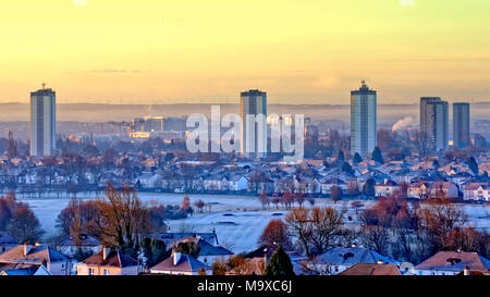 Glasgow, Scotland, UK 29th March 2018. UK Weather: Freezing morning with fog and mist causes a spectacular dawn and fog picturesque start over the city.The greens of Knightswood golf course turn white in the shadow of scotstoun towers and the titan crane on the Clyde sits beside the queen Elizabeth university hospital as the mist stratifies the south of the city under the Whitlee wind farm in the distance in the hills above Glasgow Gerard Ferry/Alamy news Stock Photo