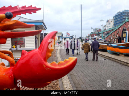 Crawley UK 29th March 2018  - A seafront walk on a dull blustery day in Brighton today with cool unsettled weather forecast for the forthcoming Easter Bank Holiday weekend   Credit: Simon Dack/Alamy Live News Stock Photo