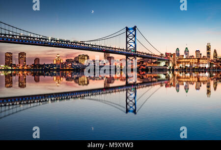 Philadelphia night skyline and Ben Franklin Bridge refection from across the Delaware River Stock Photo