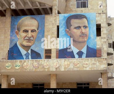 Presidents of Syria. Left: Hafez al-Asad (1930-2000), right: Basahr al-Assad (1965). Large portraits. Hamidie souk. Damascus. Picture took before the Civil War. Stock Photo