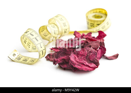 Dried beetroot chips and measuring tape isolated on white background. Stock Photo