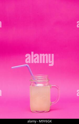 Healthy lemonade  in a glass jar on a pink background Stock Photo