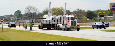 The F-15 displayed in front of Bldg. 215 was removed from its pedestal and transported by the 402nd Aircraft Maintenance Group to the Air Logistics Complex for repainting, March 24, 2018.  Georgia Highway 247 was blocked to allow movement of the jet to a base painting facility. Once repainted, the aircraft is planned to be situated next to the Robins Airman’s Memorial at the Museum of Aviation. (U.S. Air Force photo by Misuzu Allen) Stock Photo