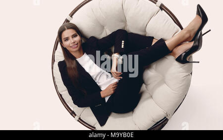 business woman thinking,sitting in a round chair Stock Photo