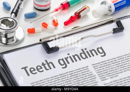 The diagnosis Teeth grinding on a clipboard Stock Photo