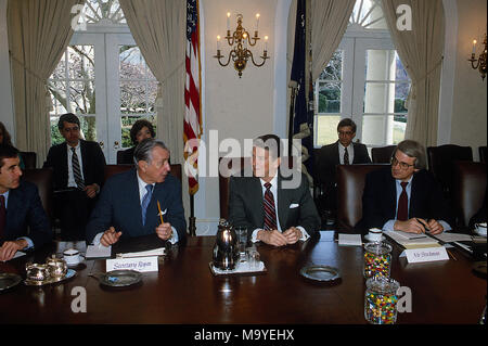 Washington DC., USA, October, 1985 President Ronald Reagan meets with (L) Secretary of the Treasury Donald Regan and (R) OMB director David Stockman in the cabinet room. Note the jars of jelly beans on the table. Credit: Mark Reinstein/MediaPunch Stock Photo