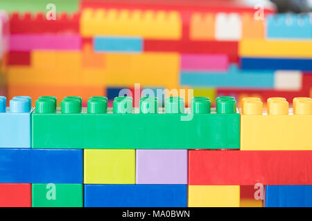 Colorful stacked toy plastic building blocks Stock Photo