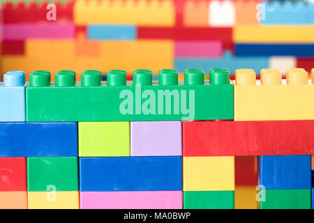 Colorful stacked toy plastic building blocks Stock Photo