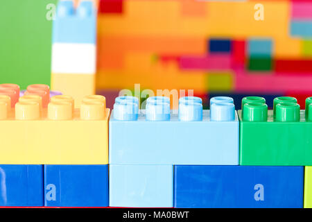 Colorful stacked toy plastic building blocks Stock Photo