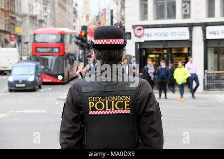 City of London Police logo on back of uniform jacket of policewoman (police woman) on the street in Farringdon area of Central London UK  KATHY DEWITT