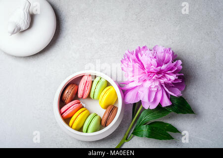 Flower peony, macaroons on grey background. Happy birthday, annivarsary concept Stock Photo