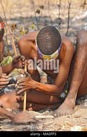 San bushman show how they light a fire in the Kalahari desert in Ghanzi, Botswana. Stock Photo