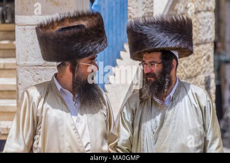 Two orthodox Jewish men walking on the street in Mea Shearin district, Jerusalem, Israel. Stock Photo