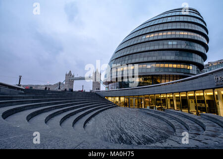 VIew of the amphitheatre at Scoop London and City Hall in the foreground and Tower Bridge in the distance. Photographed at dusk. Stock Photo