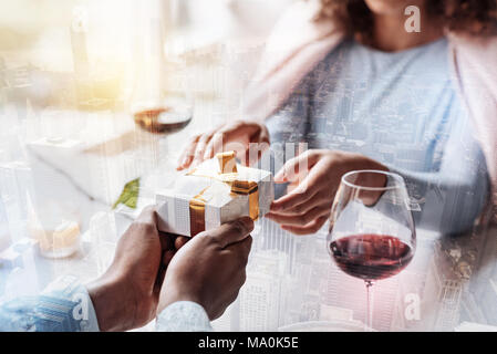 Young man making present for his woman Stock Photo