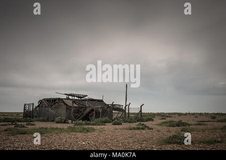 An old wooden building at Dungeness in Kent, most of the top floor has collapsed and from what I can tell the rest of it hasn't got long to go. Stock Photo