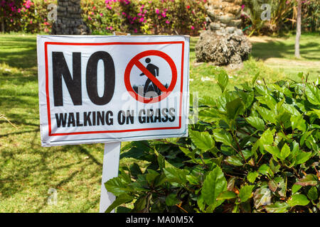 No walking on grass warning sign in the garden. Stock Photo