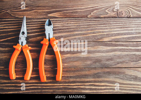 pliers and side cutters on wooden background. Stock Photo