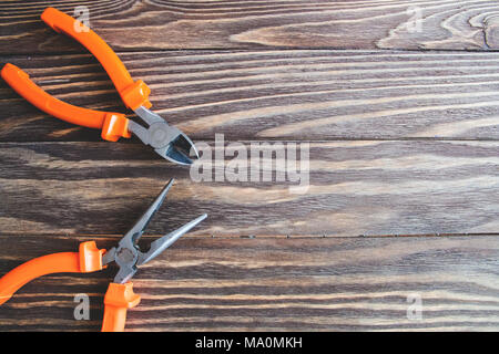 pliers and side cutters on wooden background. Stock Photo