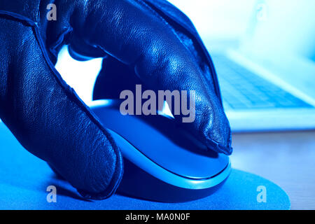 Close Up Of Cyber Criminal In Gloved Hand Using Computer Mouse Stock Photo