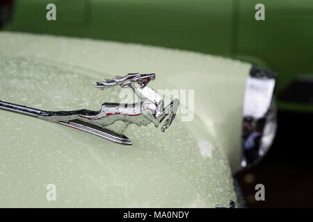 MOSCOW, RUSSIA - AUGUST 26, 2017: Close-up of shiny chrome plated deer on the hood of the retro car GAZ M21 Volga, vintage car, selectiv focus. Retro  Stock Photo