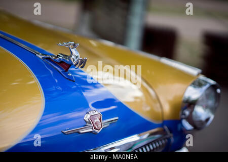 MOSCOW, RUSSIA - AUGUST 26, 2017: Close-up of shiny chrome plated deer on the hood of the bicolour retro car GAZ M21 Volga, vintage car, selective foc Stock Photo