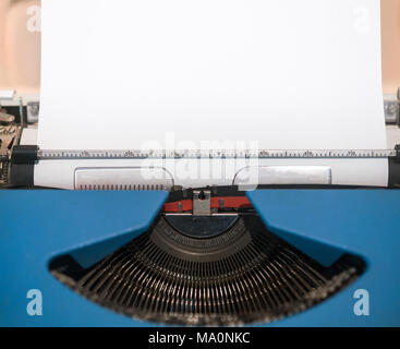 Old Typing Machine, with blank white sheet, waiting for your ideas Stock Photo