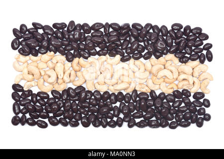 Cashew nuts and raisins in dark chocolate on white background Stock Photo