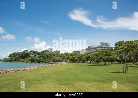 Darwin,Northern Territory,Australia-February 21,2018:Landscaped park with lush natural rainforest border and the Parliament House in Darwin, Australia Stock Photo