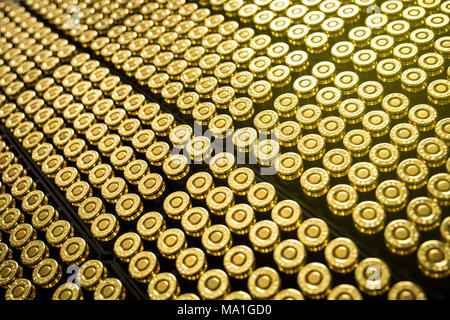 Hundreds of brass ammo rounds lined up together Stock Photo