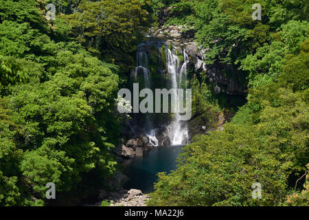 Cheonjeyeon 2nd waterfall. Cheonjeyeon is a three-tier waterfall, which is one of the most famous falls in Jeju island, Korea. Stock Photo