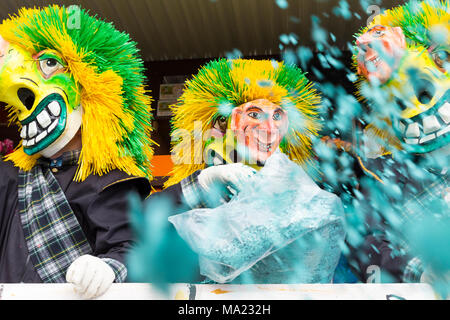 Basel carnival. Steinenberg, Basel, Switzerland - February 21st, 2018. Close-up waggis clowns throwing confetti into the crowd Stock Photo