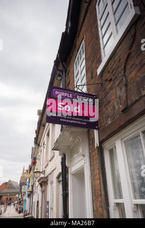 Purple Bricks Group PLC estate agents sold sign on a terraced house