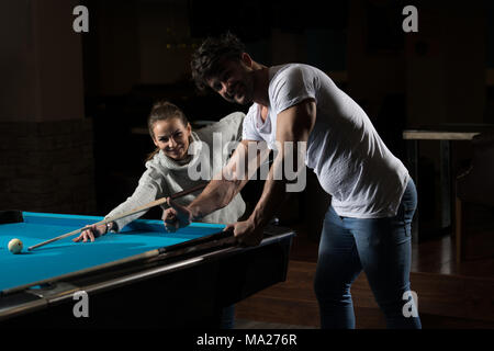 Young Caucasian Woman Receiving Advice On Shooting Pool Ball While Playing Billiards Stock Photo