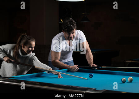 Young Caucasian Woman Receiving Advice On Shooting Pool Ball While Playing Billiards Stock Photo