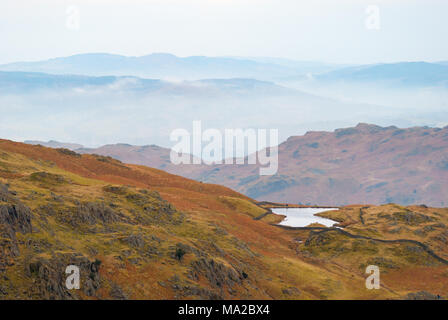 Misty landscape high in the hills in the English Lake District above Grasmere, Cumbria, UK Stock Photo