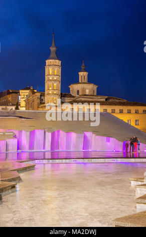 ZARAGOZA, SPAIN - MARCH 2, 2018: The tower of church Iglesia de San Juan de los Panetes and modern fountain on the Plaza del Pilar. Stock Photo