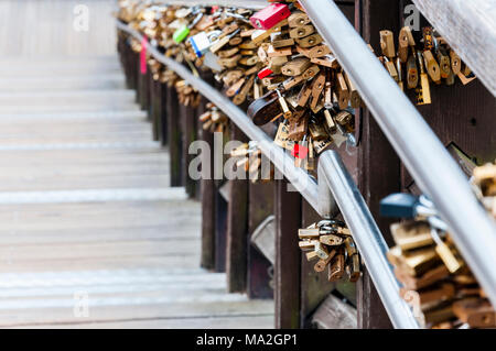 Hundreds of love locks hanging on a bridge in Venice Stock Photo