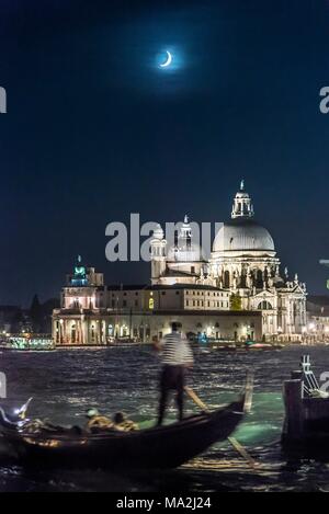 An moonlit, evening gondola ride with the church of Santa Maria della Salute, Venice, Italy Stock Photo