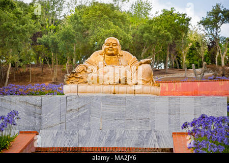 One of the many statues of Buddha in the Buddha Eden Garden, consisting of 35 hectares (86 acres) of natural fields, lakes, manicured gardens an hour  Stock Photo