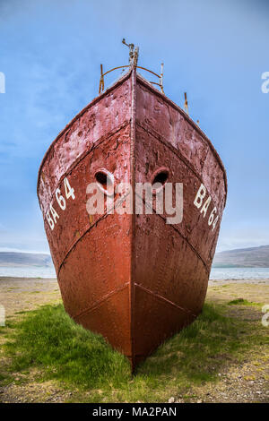 Oldest steel ship in Iceland abandoned rusty ashore in the grass, West Fjords, Iceland Stock Photo