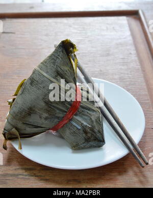 sticky rice steam with pork and salt egg in banana leaf of Chinese Duanwu festival Stock Photo