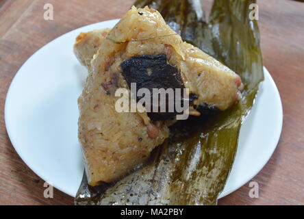 sticky rice steam with pork and salt egg in banana leaf of Chinese Duanwu festival Stock Photo