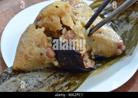 sticky rice steam with pork and salt egg in banana leaf of Chinese Duanwu festival Stock Photo